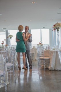 Caucasian couple dancing in empty restaurant