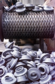 Plastic manufactured pieces on conveyor belt