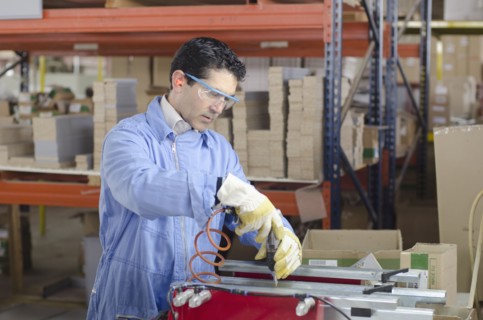 Hispanic technician working in factory
