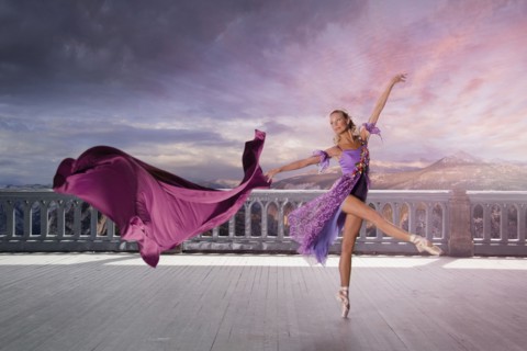 Caucasian woman ballet dancing on balcony