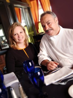 Chef and restaurant owner smiling