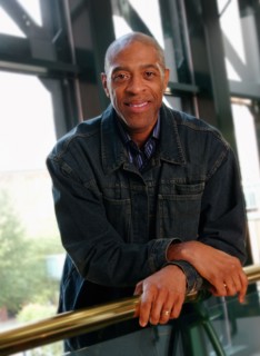 Smiling man leaning on banister