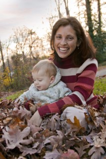 Mother and son sitting in autumn leaves
