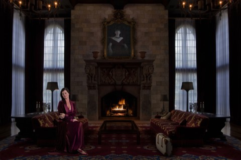 Caucasian woman sitting in ornate living room