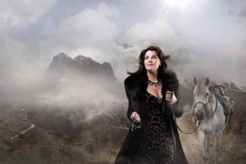 Caucasian woman walking horse in remote landscape