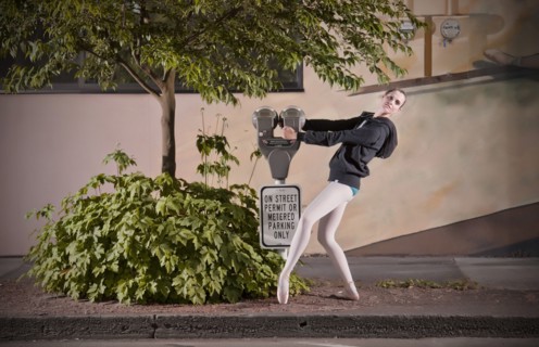 Caucasian ballet dancer posing with parking meter