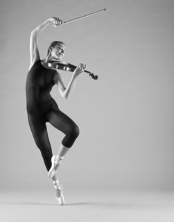 Caucasian ballet dancer playing violin