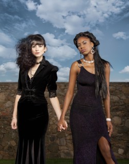 Women in black dresses holding hands