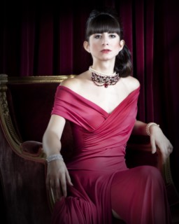 Caucasian woman wearing jewelry and red evening gown