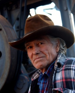 Man wearing cowboy hat looking at camera