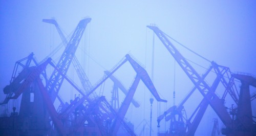 Construction cranes in fog