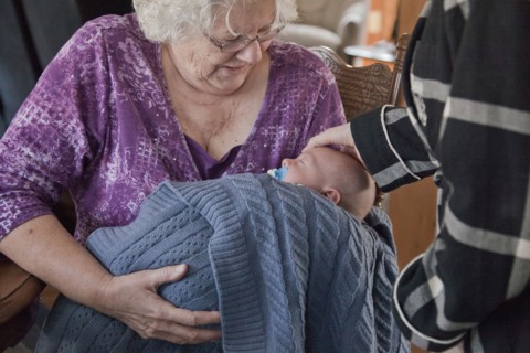 Caucasian grandmother holding baby grandson