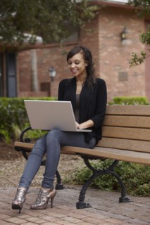 Mixed race woman typing on laptop