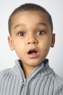 Mixed race boy with surprised expression
