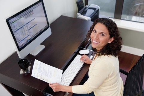 Hispanic woman paying bills on computer