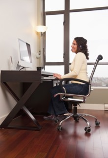 Hispanic woman in headset working on computer