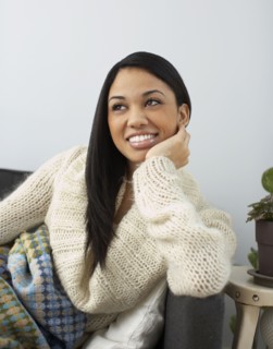Smiling woman sitting on sofa