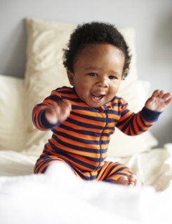 African American boy sitting on bed