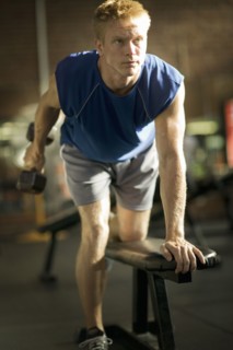 Man lifting weights in health club