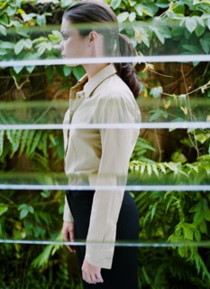 Woman behind window in greenhouse