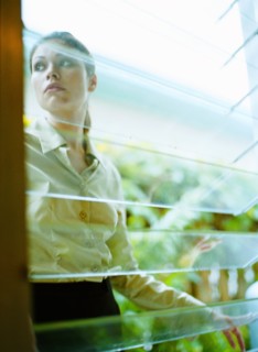Woman behind window in greenhouse