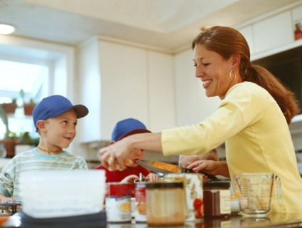 Caucasian mother and sons preparing food