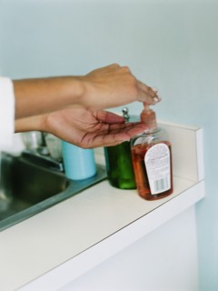 Woman using hand sanitizer