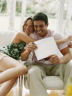 Couple hugging and holding certificate