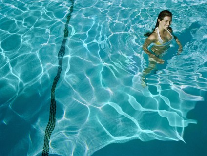 Woman standing in swimming pool