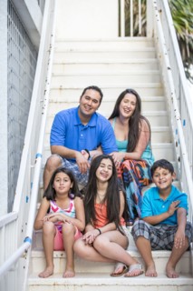 Hispanic family smiling on staircase
