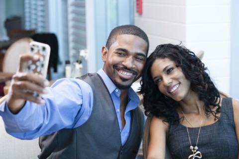 Business people taking selfie with cell phone in office