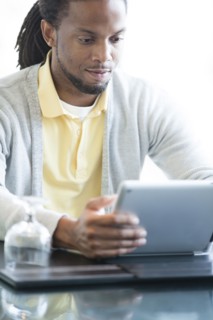 African American businessman using digital tablet in restaurant