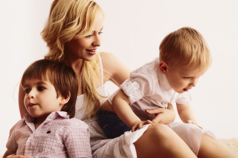 Smiling mother holding sons