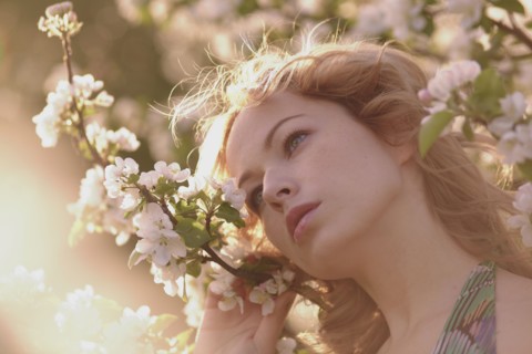 Caucasian woman standing in flowering tree