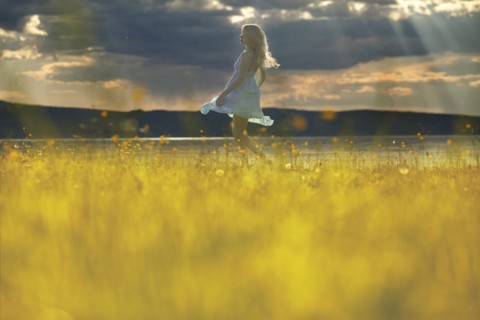 Caucasian woman walking in rural field