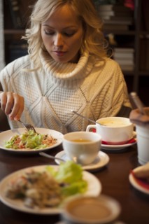 Caucasian woman eating at table