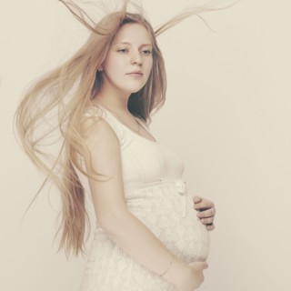 Pregnant woman with windblown hair