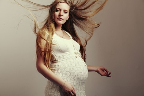 Pregnant woman with windblown hair