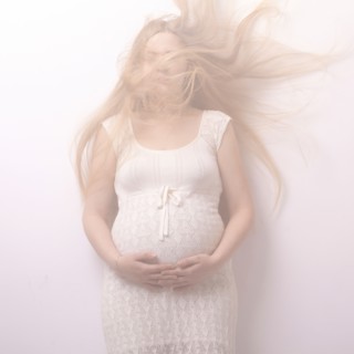 Pregnant woman with windblown hair