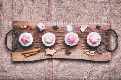 Cupcakes on ingredients on wooden tray