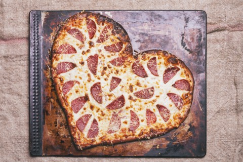 Heart-shaped pizza on pan