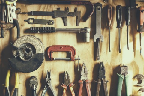 Tools hanging on wooden wall