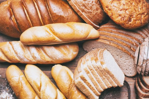 Loaves and sliced bread on table