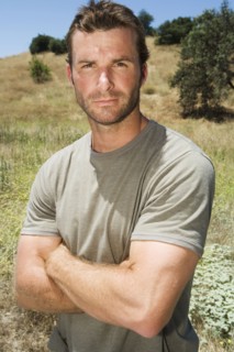 Serious man standing in remote field