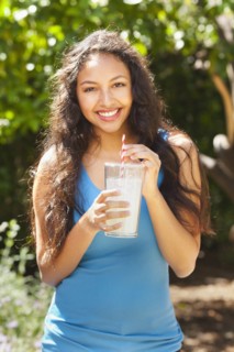 Mixed race woman drinking lemonade outdoors