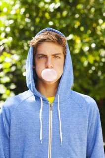 Caucasian teenager blowing bubble with gum