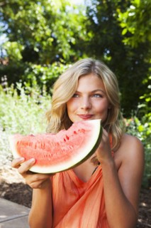 Caucasian girl eating watermelon