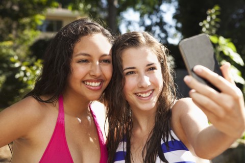 Friends taking self-portrait with cell phone