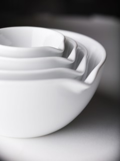 Close up of white nesting bowls with spouts