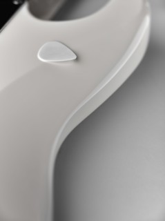 Close up of white electric guitar with guitar pick